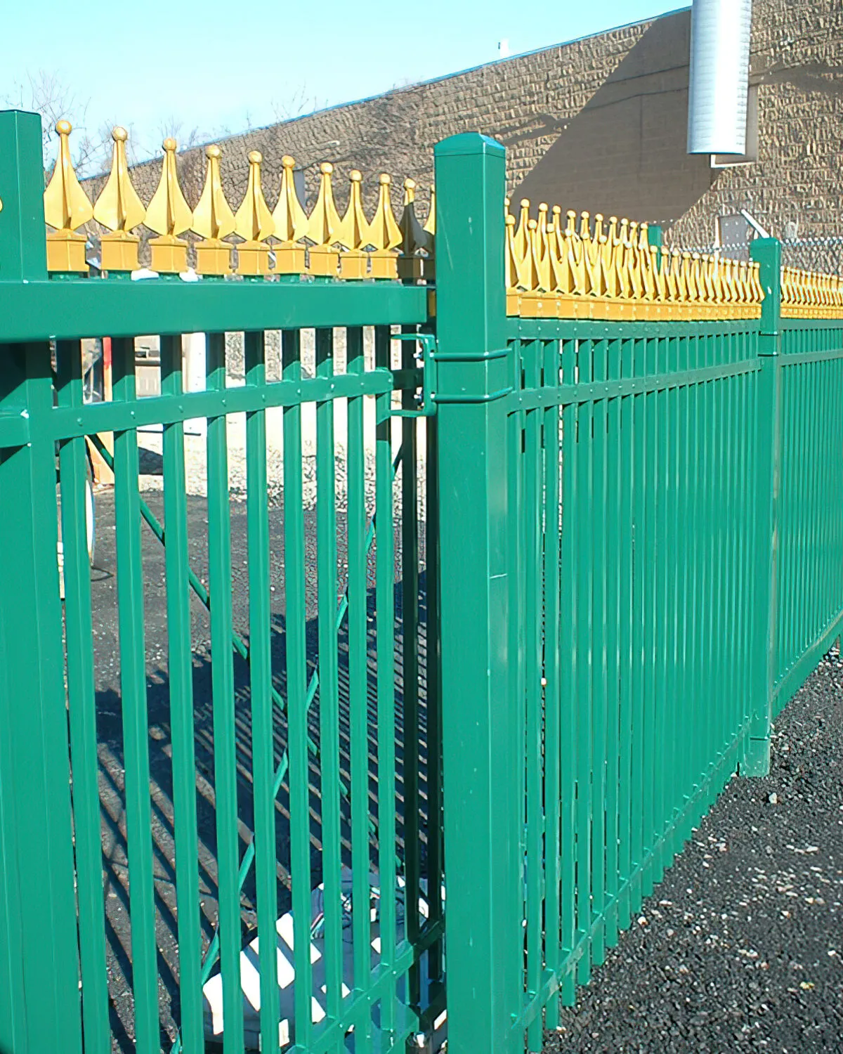 Tall steel slide gate securing a commercial property entrance