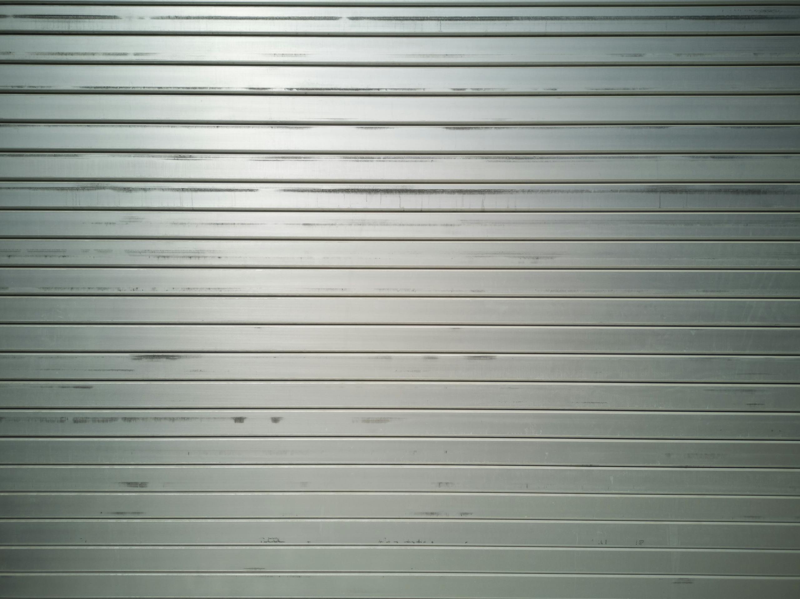 Flat metal surface with horizontal lines and subtle texture, ideal for backgrounds.